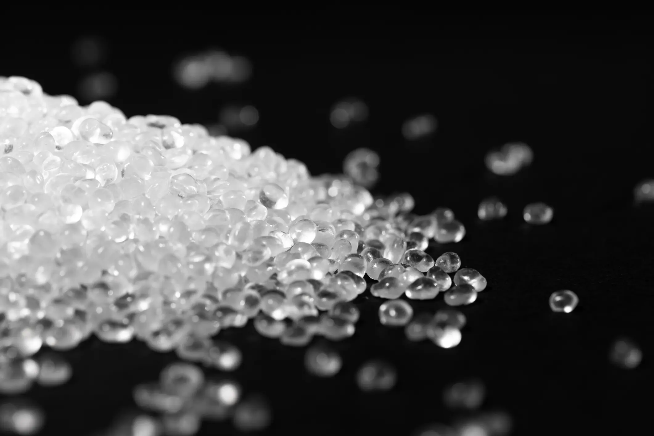Transparent polypropylene granules plastic pellets material on black background